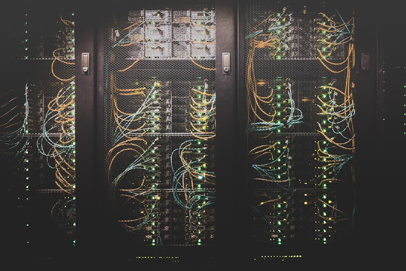 Rows of server racks glowing in a dim data center aisle